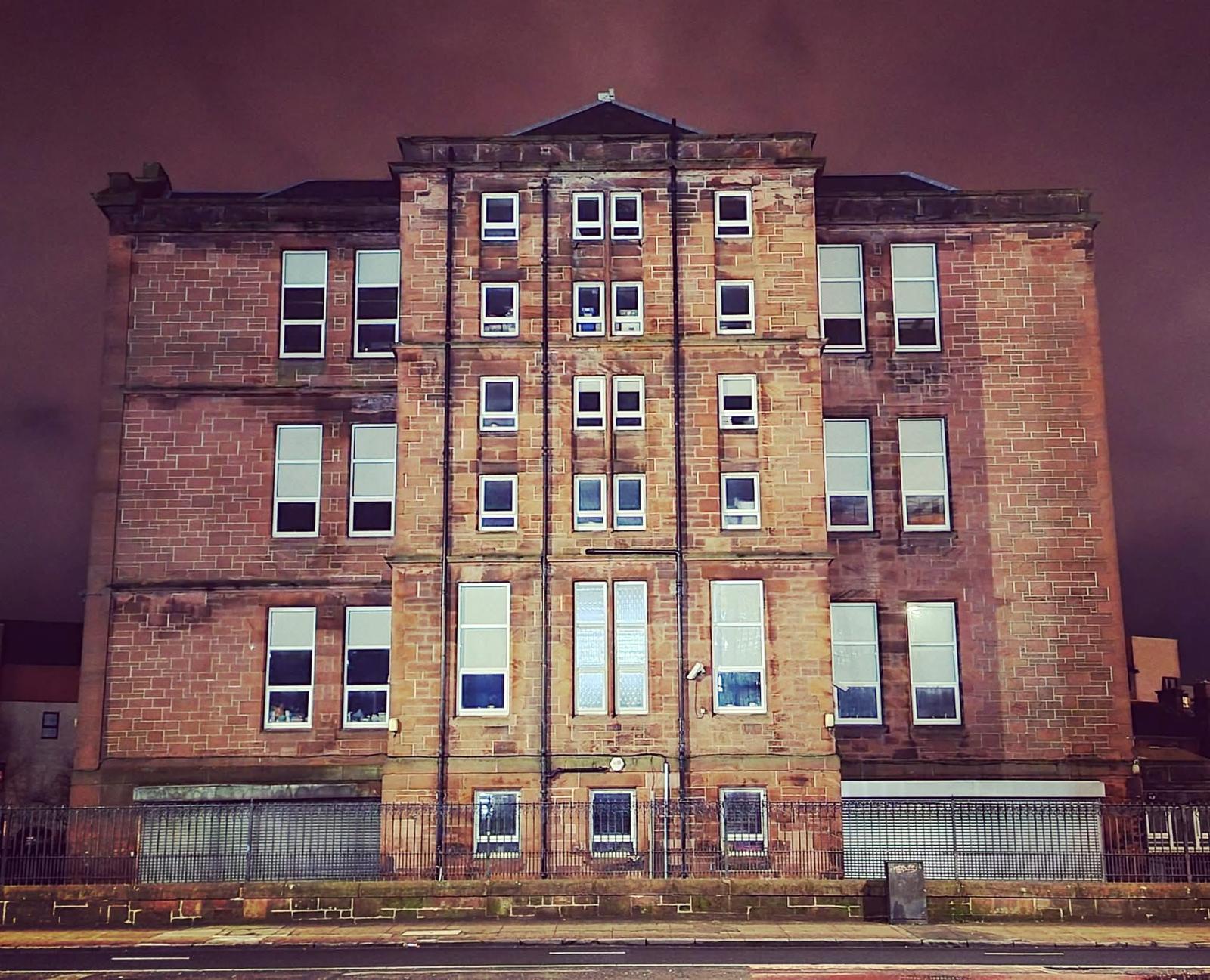 A traditional red-sandstone tenement block in Glasgow